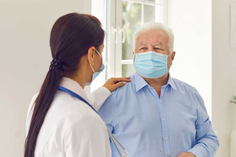 Older man talking with doctor